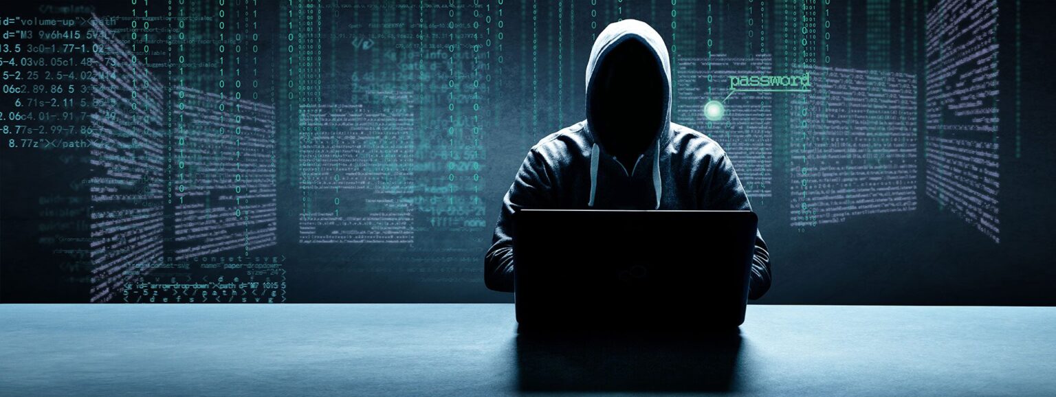 hacker with hood up and no visible face surrounded by code