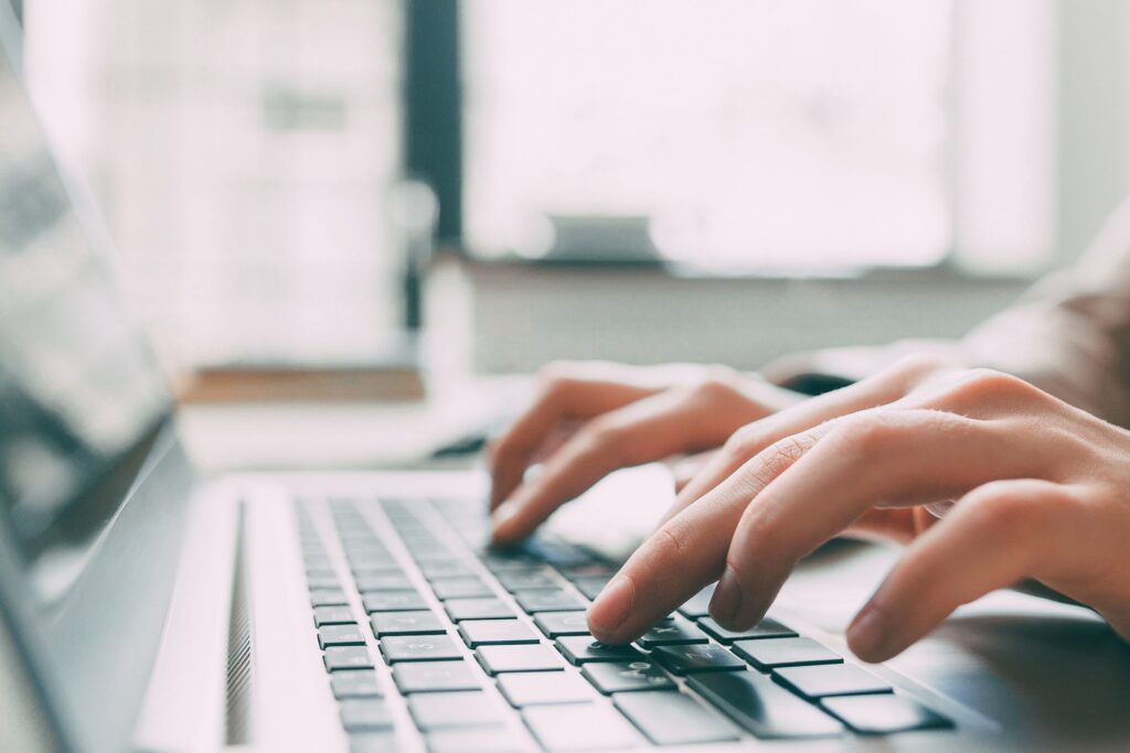 someone typing on a laptop