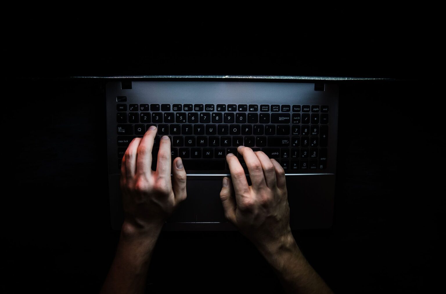 someone typing on a laptop