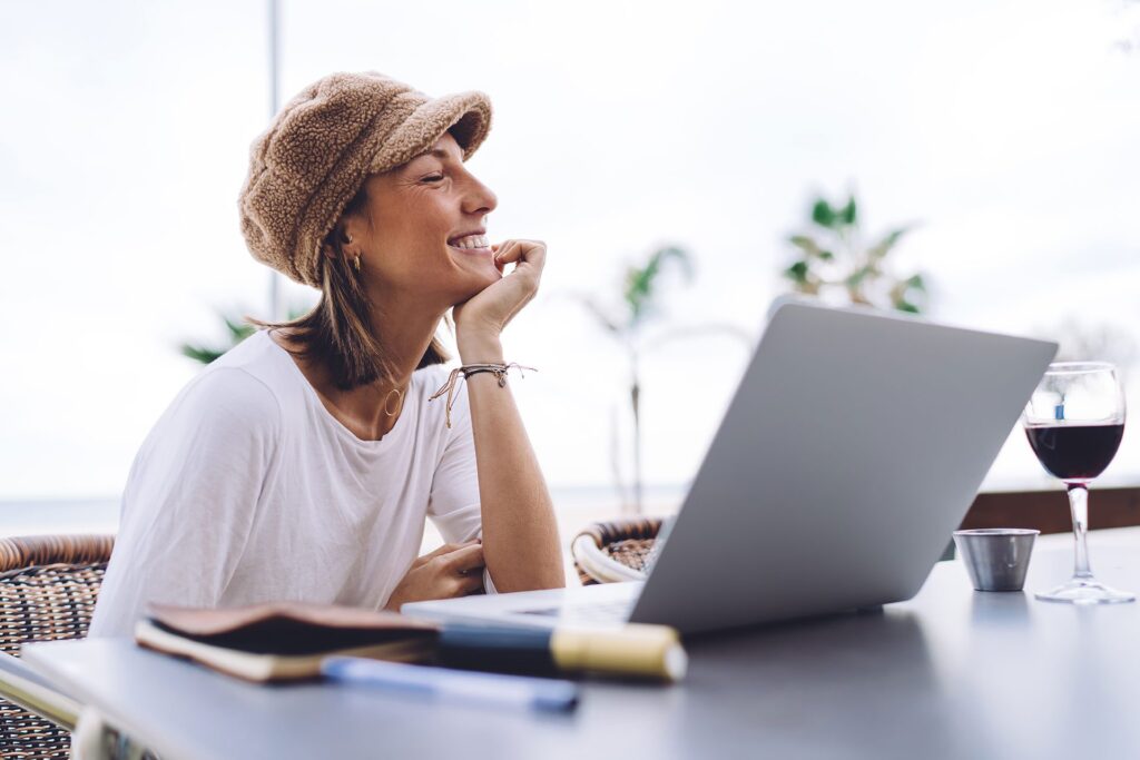 woman smiling at desk with laptop open